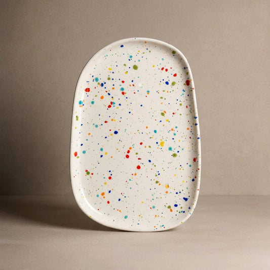 Rectangular ceramic tray with multicolored speckles on a beige background
